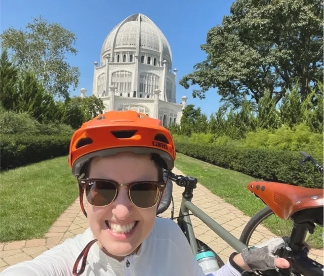 Cheyanne next to her bike, with the Ba'hai House of Worship in the background.